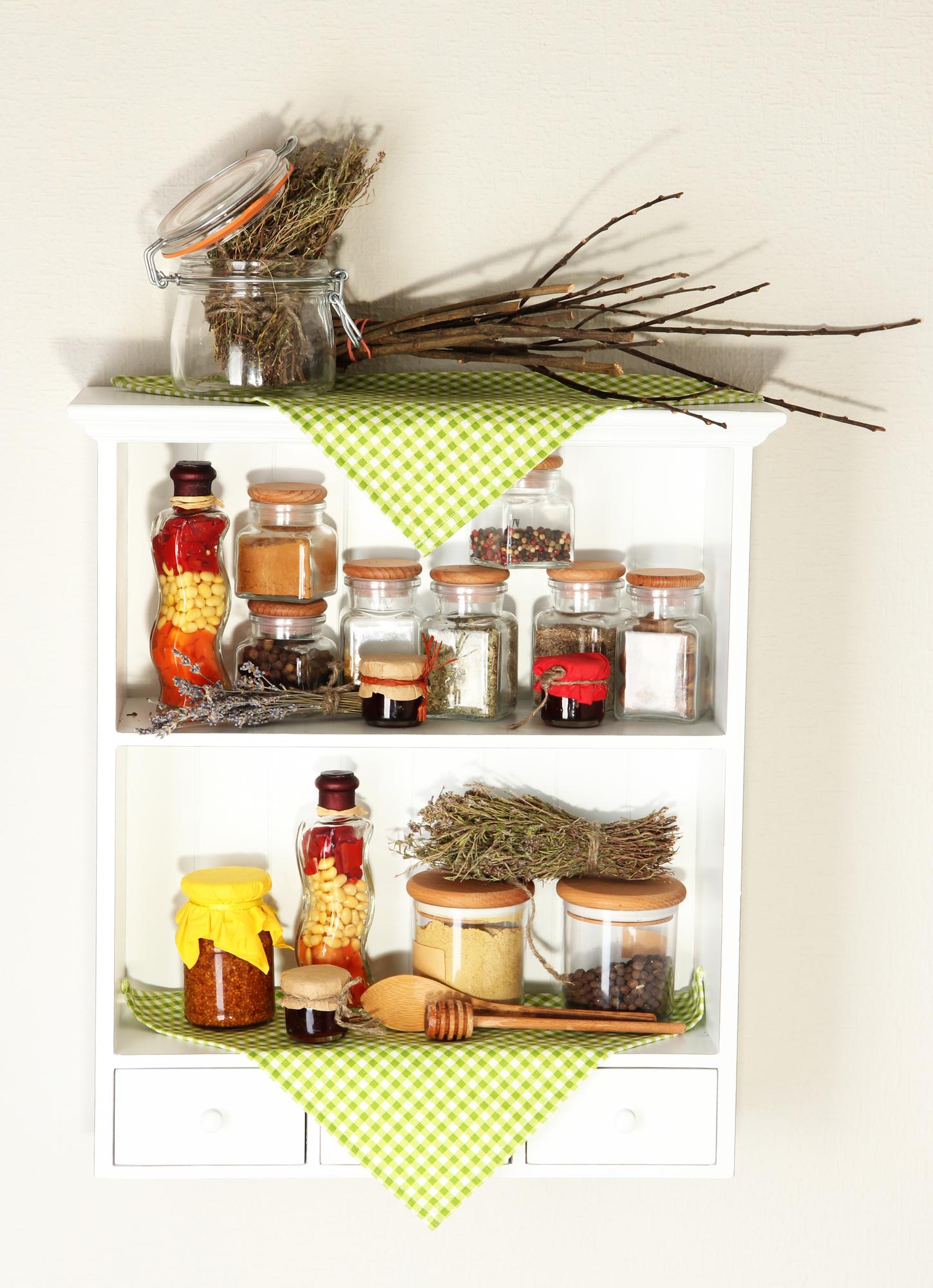 studio shelf with jars, fresh herbs and notebooks